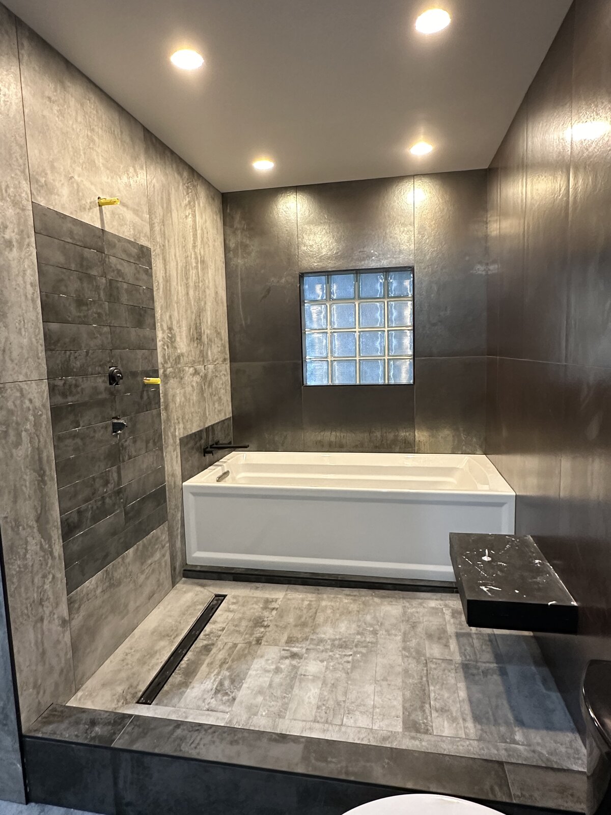 Spa-Style Bathroom, Large Format Tile — metallic finish with recessed lighting